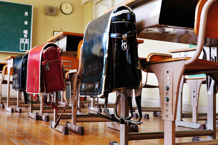 Japanese backpacks hanging on desks