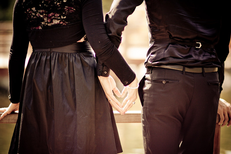 A couple holding hands forming a heart shape