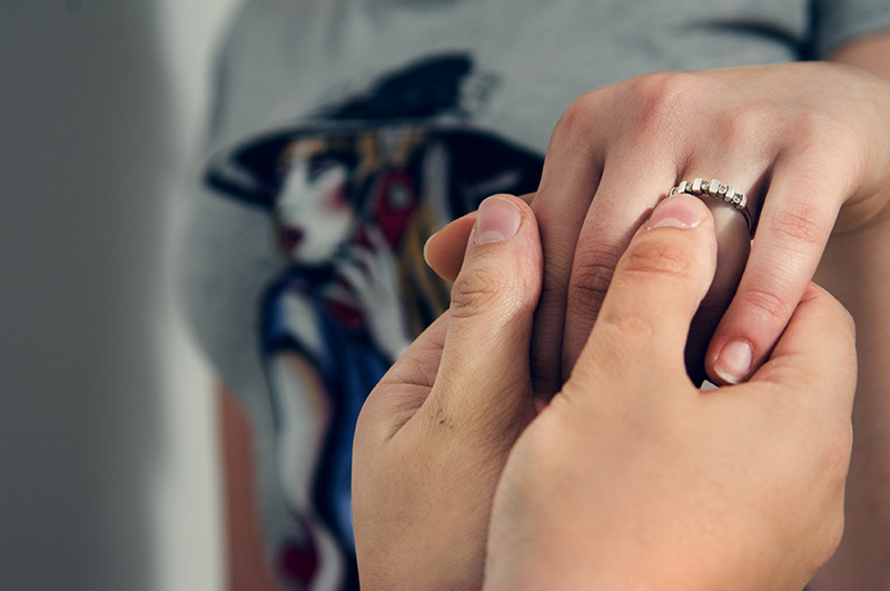 Person putting a ring on their lover's finger