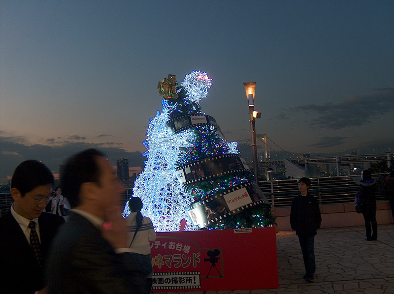 godzilla made of christmas lights attacking tree