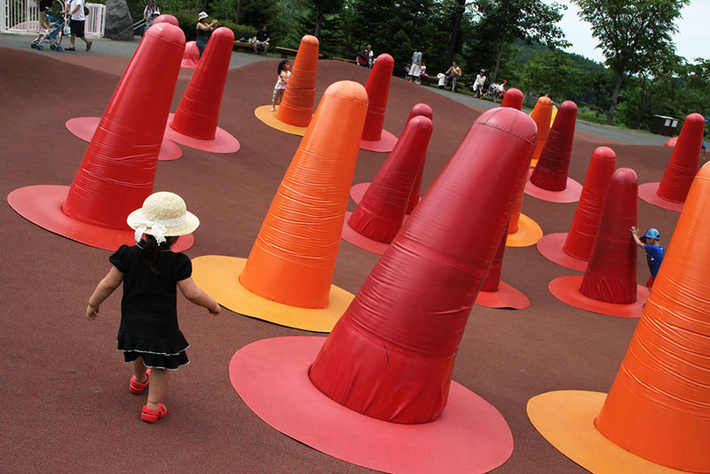 small japanese child navigating red cones