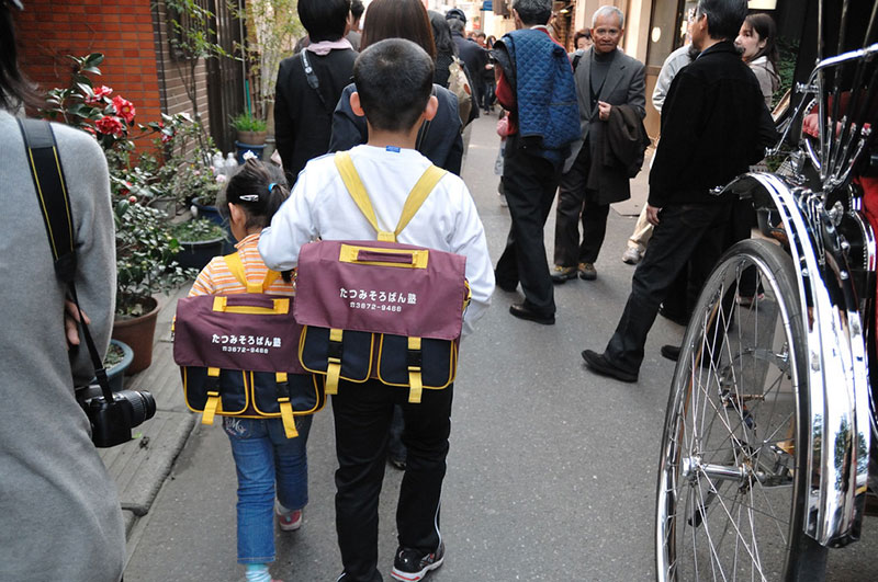 japanese boy leading his brother to from school