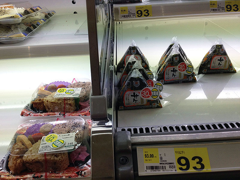 Onigiri in a display case priced at 93 yen