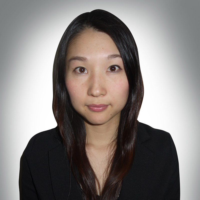 asian woman shoulders up plain background