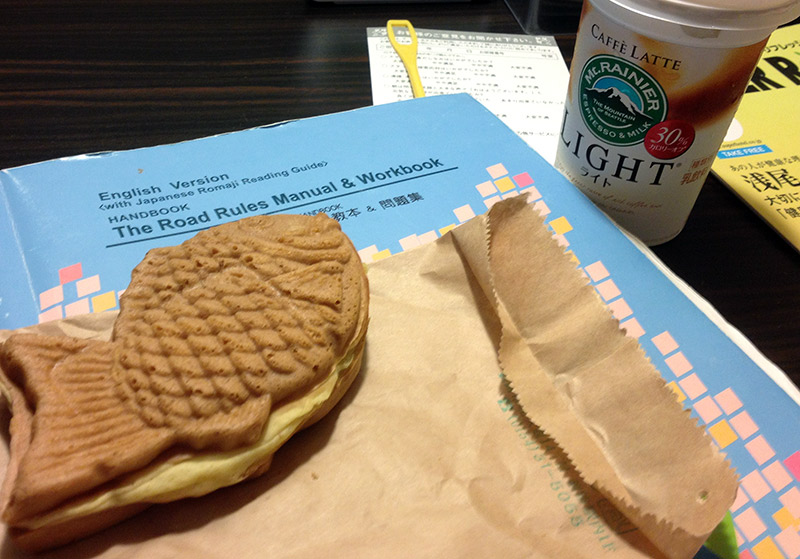 A Japanese road rules manual surrounded by food