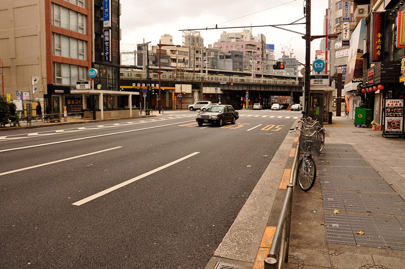 An empty Japanese street with a lone taxicab