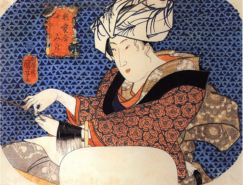 woman with blue background wearing tenugui