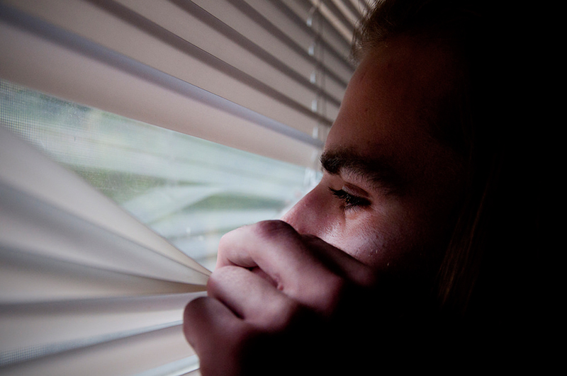 hikikomori man looking through blinds