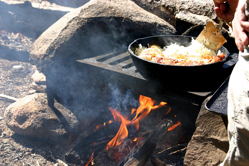 hash browns being cooked on outdoor wood grille
