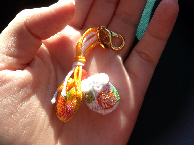 holding omamori for happiness
