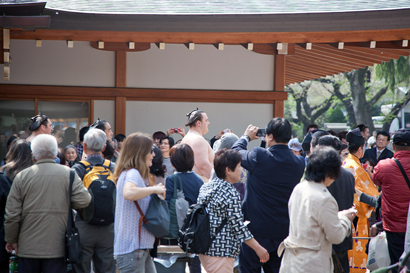 caucasian sumo wrestler amidst crowd