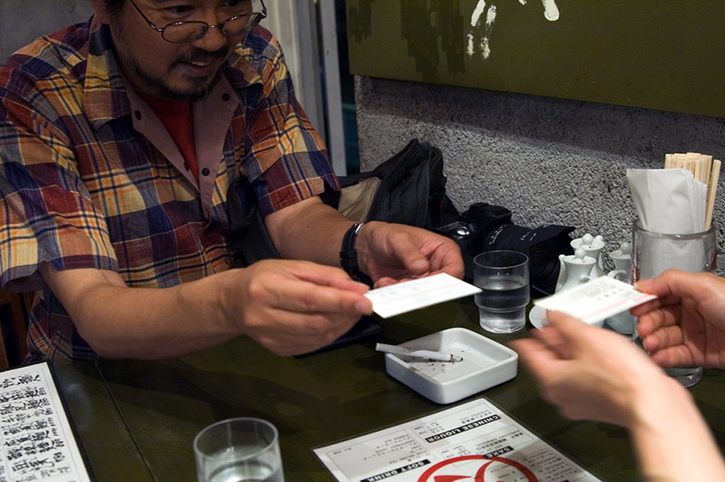 two men exchanging japanese business cards