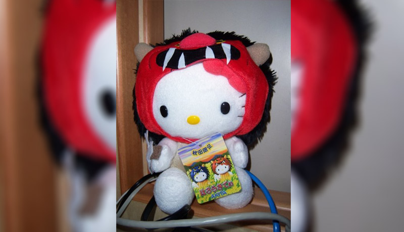 Hello Kitty dressed in a red ogre mask