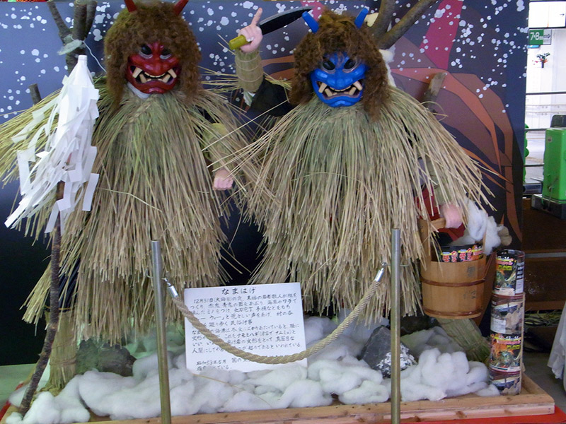 Red and blue-faced ogre statues with knives and buckets