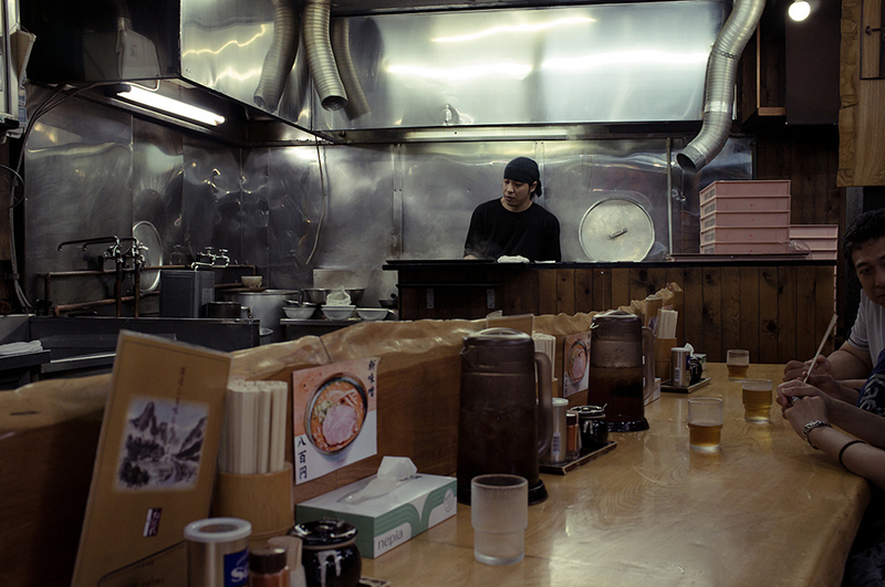 man cooking ramen at ramen store