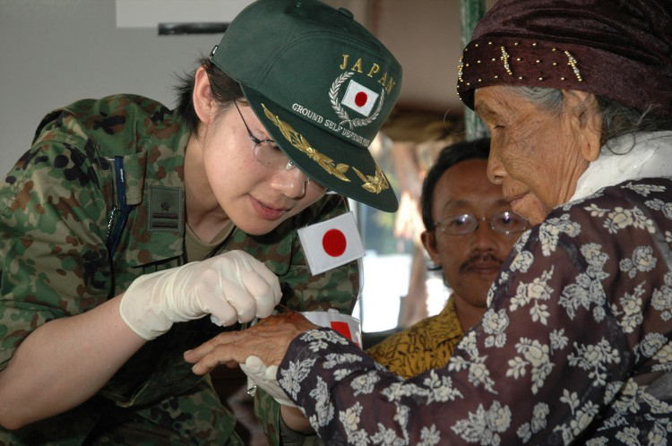 JSDF Personnel assisting an elderly woman in Indonesia