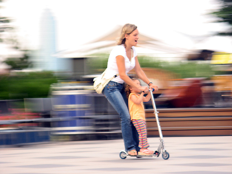 mother and daughter riding a scooter