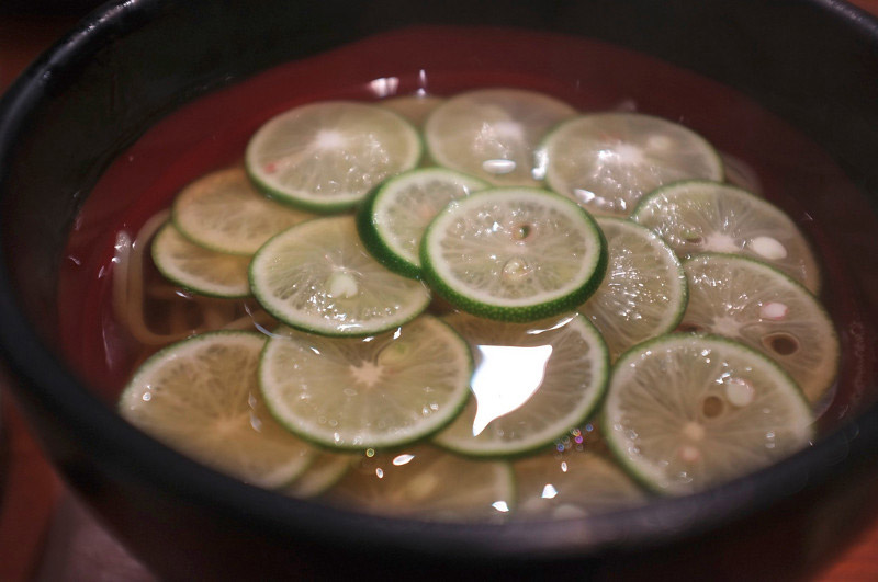 sudachi bowl of limes in a red and black bowl