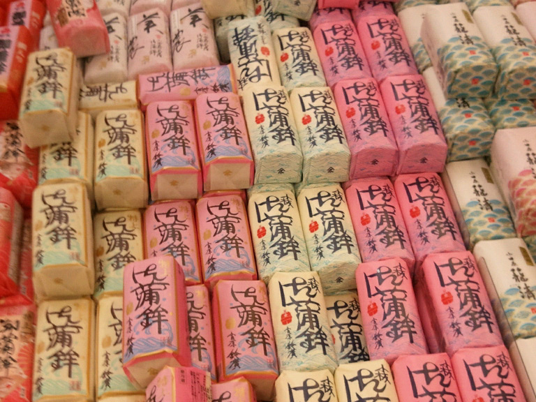 Kamaboko wrapped up in different colors in a shop