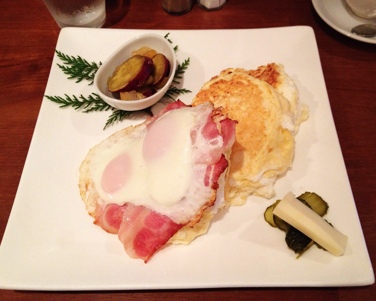 Japanese pancake breakfast with pickles and fried sides