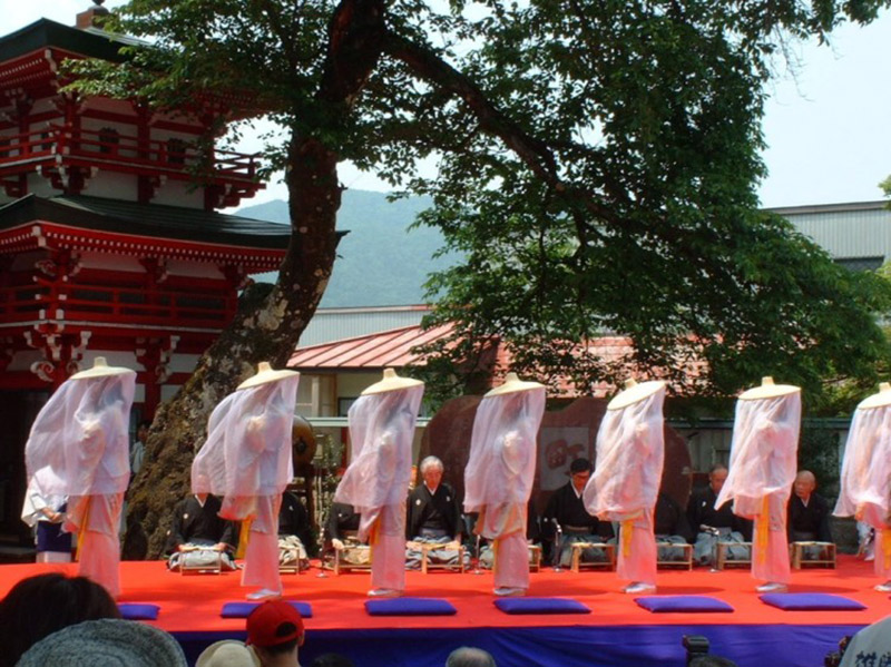 procession of veiled women in white