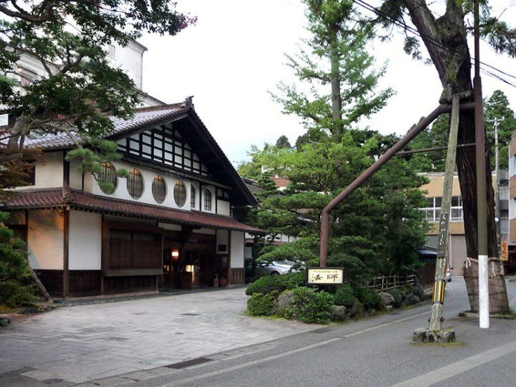 traditional-style Japanese building by Japanese pines
