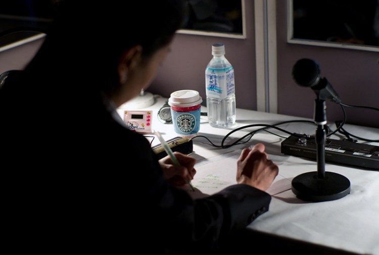 professional translator at desk with microphone
