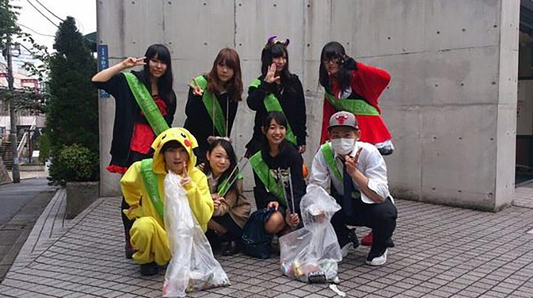 group of japanese people that volunteered to clean up halloween trash