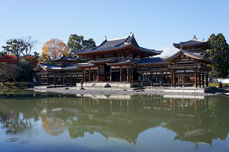 Temple with red columns and trim on a pond