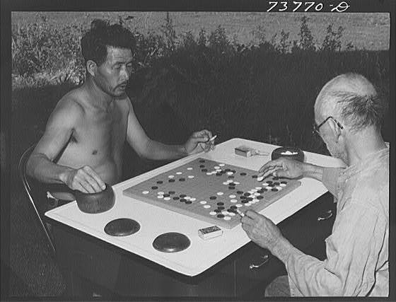 black & white photograph of men playing go