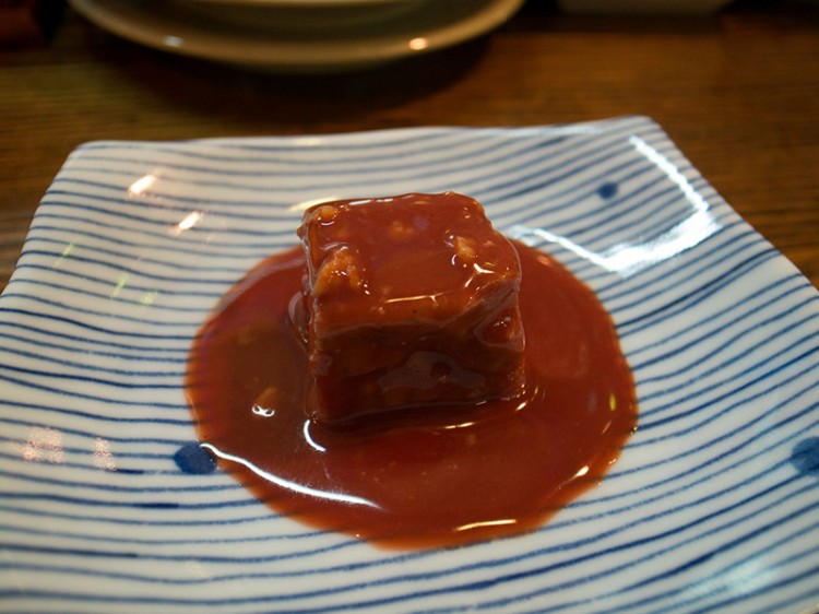 red tofu in sauce on blue and white plate