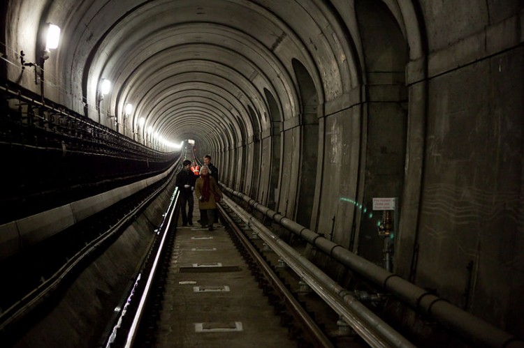 walking along rail tracks in tunnel
