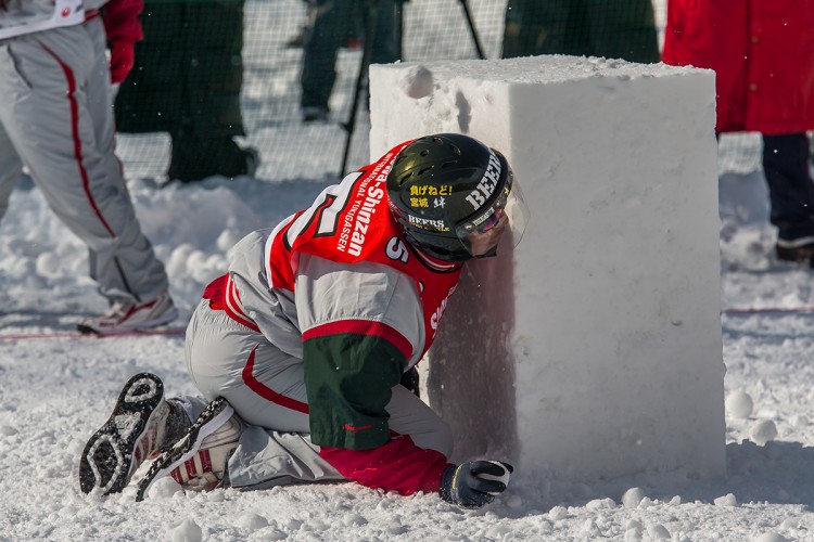 A Yukigassen player taking cover behind a wall of snow