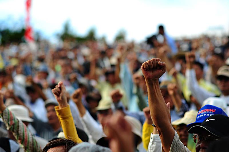 people protesting okinawan base fists up