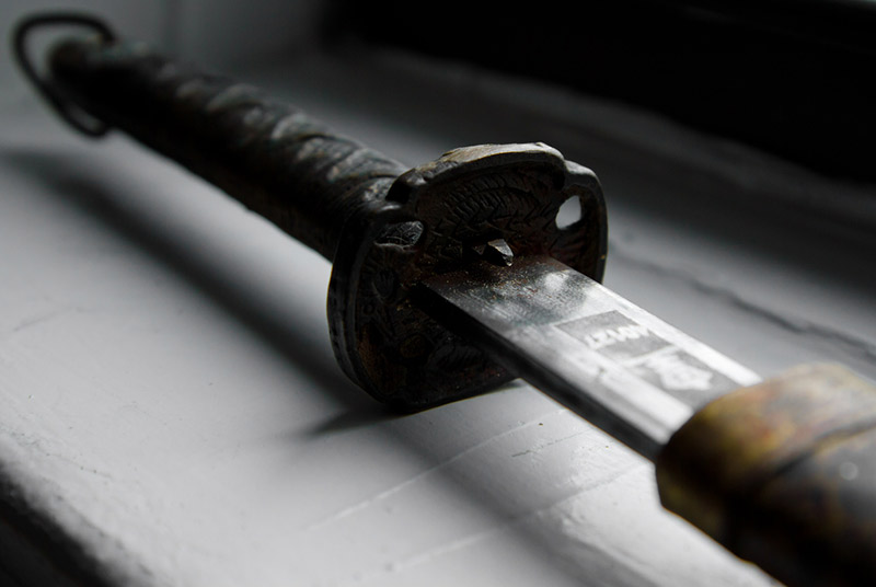 Japanese sword viewing katana sword gunto partially drawn resting on ledge