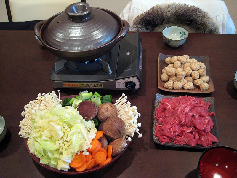 ingredients in bowls next to cooking pot