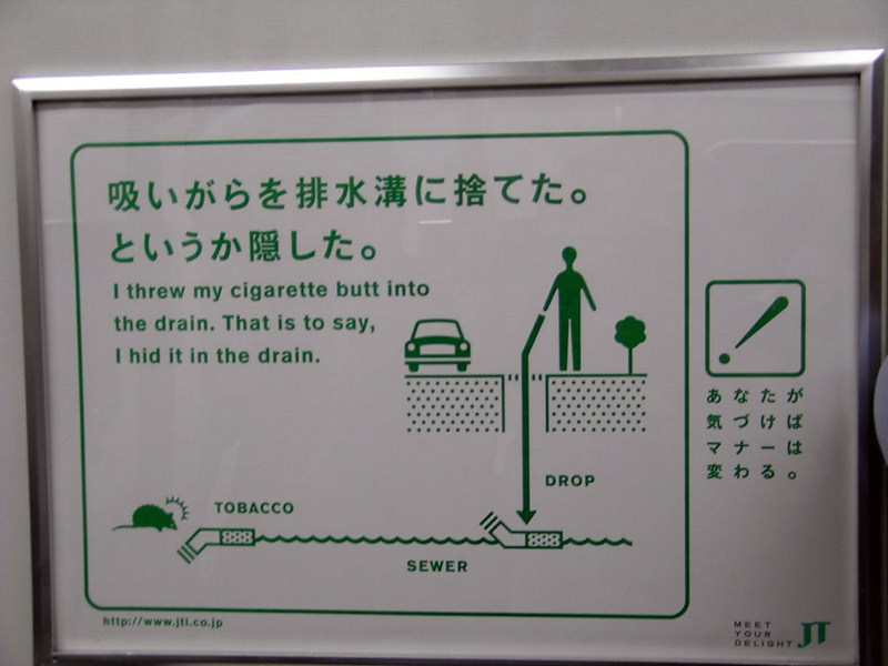 Sign reminding people not to throw away cigarettes in drains