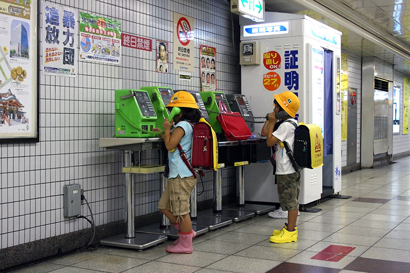 two japanese children alone on the phone