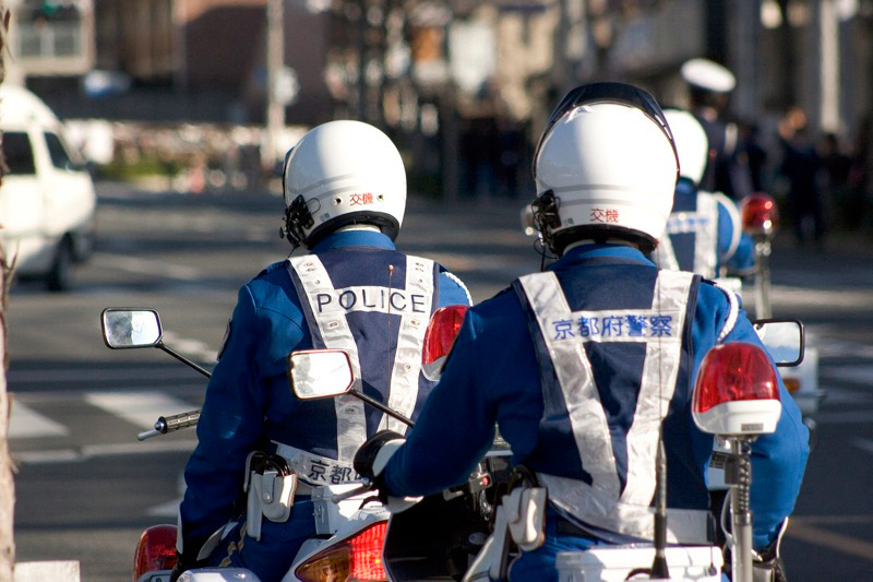 two police officers in japan riding motorcycles