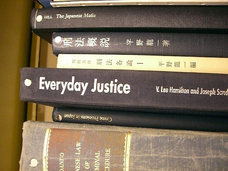 six books about japanese criminal law stacked together