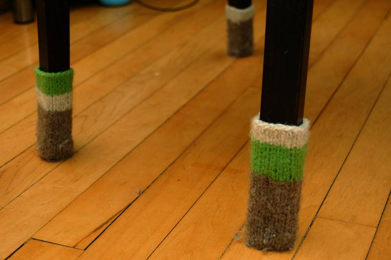 Knitted socks on the bottom of chair legs