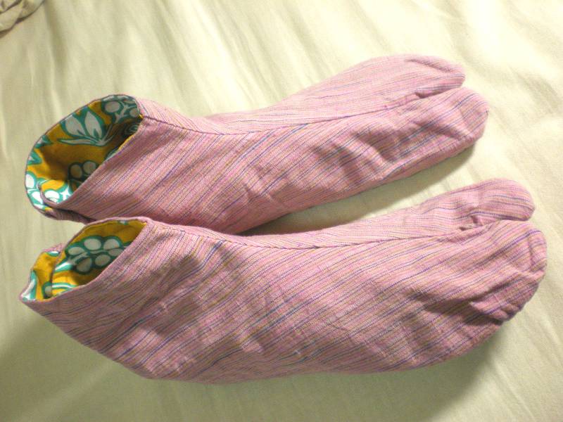 Pink tabi socks with yellow flower-print lining