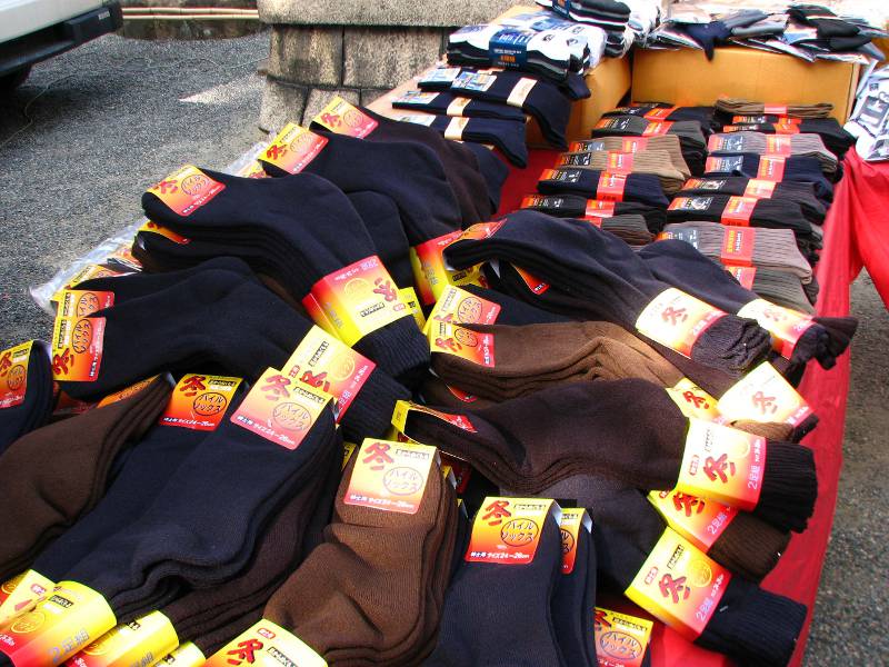 Thick socks in neutral covers piled on a table