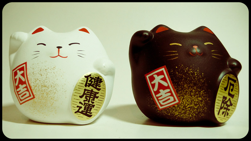 three round lucky cat sculptures