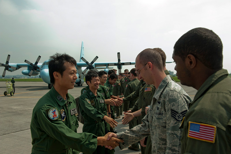personnel shake hands with members of USAF