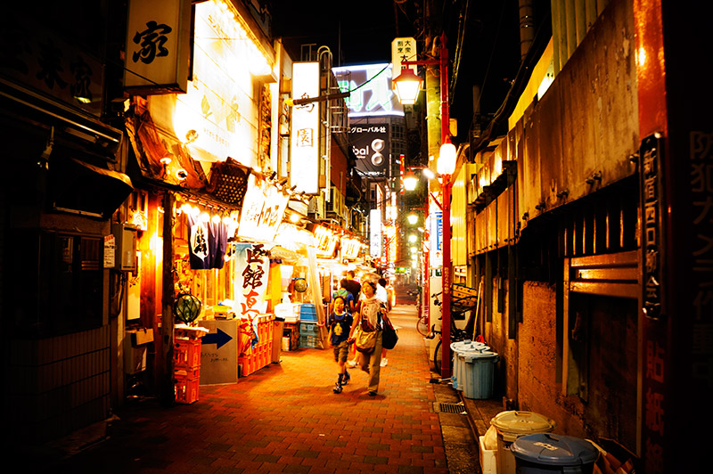 mother and sun walking down bright alley