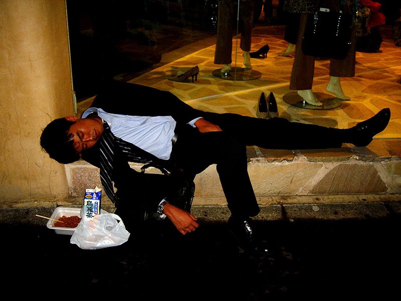 drunk man passed out on side of street