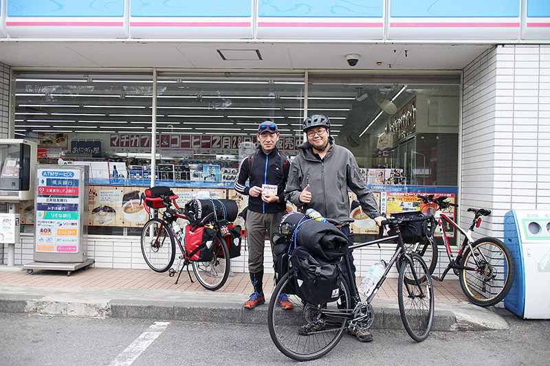 Men on a cycling trip in Japan take a break