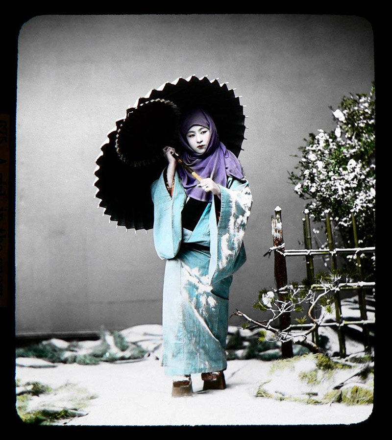 blue color girl in kimono in snow with umbrella