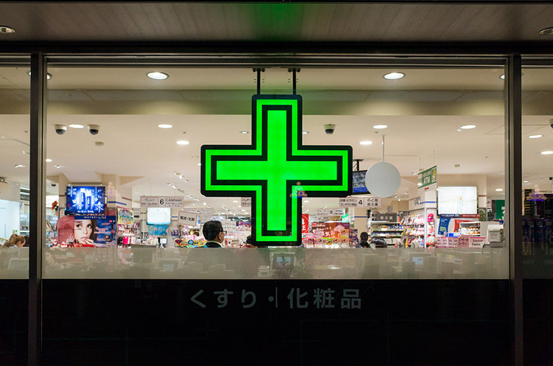 japan drug store window green cross